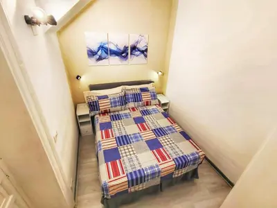 a small bedroom with two beds in a room at subway apartment in Palermo