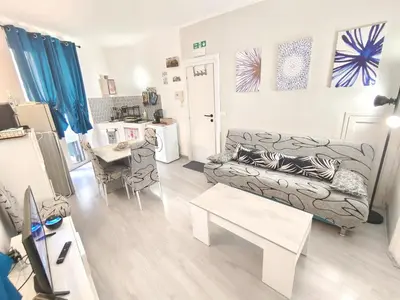 a living room with a couch and a table at subway apartment in Palermo
