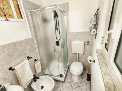 a bathroom with a shower and a toilet at subway apartment in Palermo