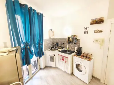 a kitchen with a washing machine and a washer and dryer at subway apartment in Palermo