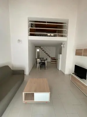 a living room with a table and a dining room at LA CASA DI ALISIA Palermo Centro in Palermo
