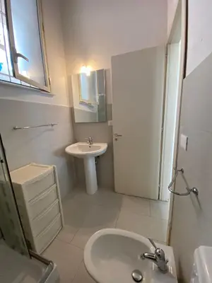 a white bathroom with a sink and a toilet at LA CASA DI ALISIA Palermo Centro in Palermo
