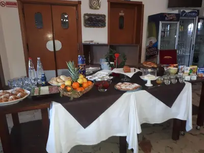 a table with food and bread and other foods on it at Hotel Il Pirata in Cinisi