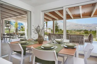 a dining room with a table and chairs at Villa Allegra in Castellammare del Golfo