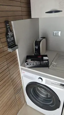 a kitchen with a washing machine and a coffee maker at Arena Dorada apartaments Margarita in Balestrate