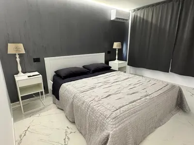 a bedroom with a large bed and two night stands at Suit home Archimede in Palermo