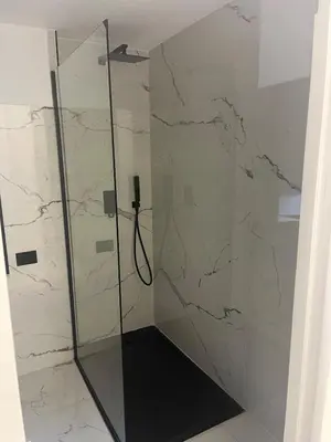 a shower with a glass door in a bathroom at Suit home Archimede in Palermo