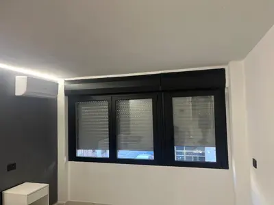 a bathroom with a window with blinds at Suit home Archimede in Palermo