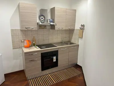 a small kitchen with a sink and a stove at My Space in Palermo