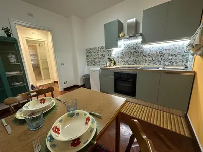a kitchen with a wooden table with plates on it at My Space in Palermo