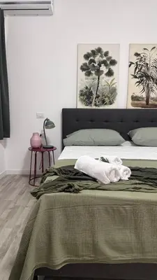 a bedroom with a bed with a towel on it at Cocciu d'amuri a casa in Terrasini