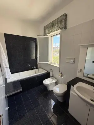 a bathroom with a tub and a toilet and a sink at 