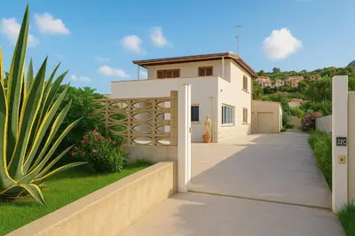a white house with a fence and a driveway at Stella Del Mare in Castellammare del Golfo