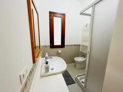 a bathroom with a sink and a mirror and a toilet at Casa Vacanza Acquanuova in Calatafimi