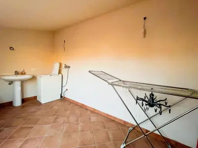 a bathroom with a sink and a shelf in a room at Casa Vacanza Acquanuova in Calatafimi