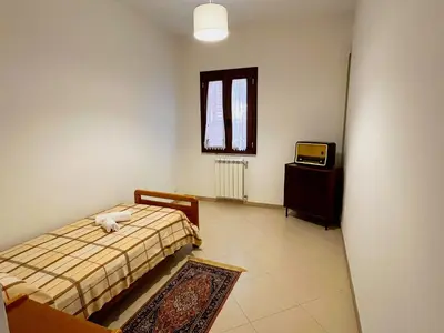 a bedroom with a bed with a cat laying on it at Casa Vacanza Acquanuova in Calatafimi