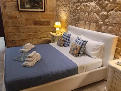 a bedroom with a bed with towels on it at Il rustico del pescatore in Balestrate
