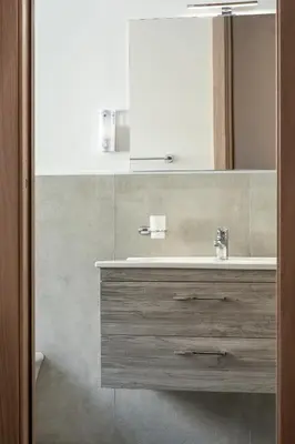 a bathroom with a sink and a glass shower at kalispera in Cinisi