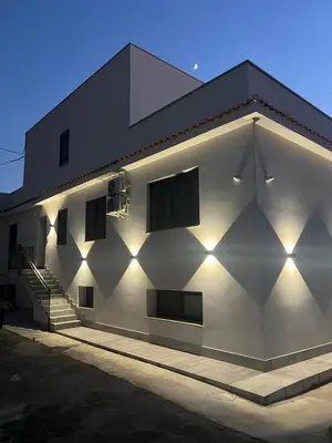 a white building with a staircase on the side of it at kalispera in Cinisi