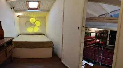 a small bedroom with a bed and a window at Ciak a Ballarò in Palermo