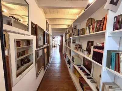 a hallway with bookshelves and shelves filled with books at Ciak a Ballarò in Palermo