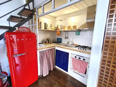 a kitchen with a red refrigerator and a stove at Ciak a Ballarò in Palermo