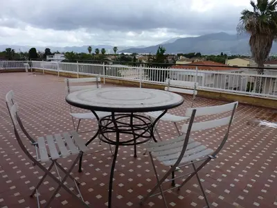 a table and chairs sitting on a patio at Terrazza 3F Mondello in Palermo