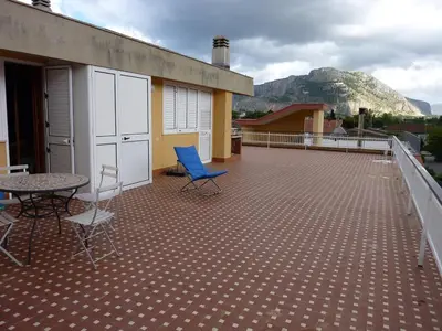 a patio with chairs and a table on a roof at Terrazza 3F Mondello in Palermo