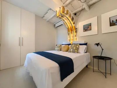 a bedroom with a bed with a blue and white blanket at Villa Teleffio in Castellammare del Golfo