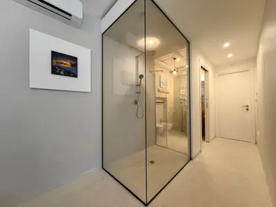 a large mirror in a hallway with a bathroom at Villa Teleffio in Castellammare del Golfo