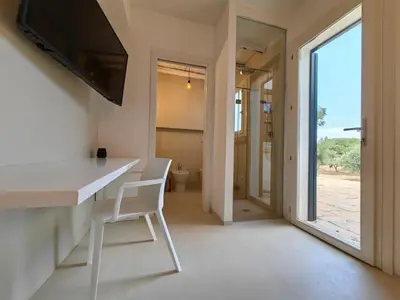 a kitchen with a white counter and a chair in a room at Villa Teleffio in Castellammare del Golfo
