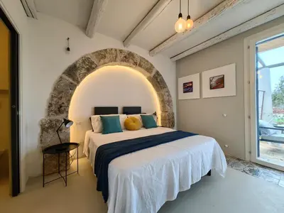 a bedroom with a bed and an archway at Villa Teleffio in Castellammare del Golfo