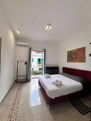 a bedroom with a large bed and a large window at Almarè Mondello in Mondello