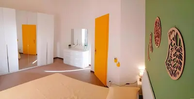a room with a bed and a yellow and green wall at Casa Cavarretta in Palermo