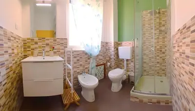 a bathroom with two toilets and a sink and a shower at Casa Cavarretta in Palermo