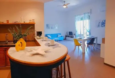 a kitchen and living room with a table and chairs at Casa Cavarretta in Palermo