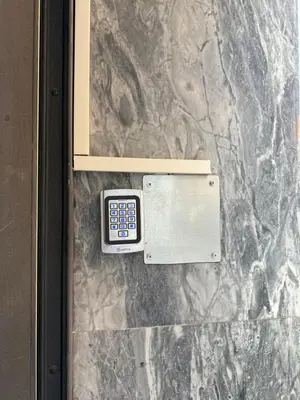 a remote control on the side of a marble wall at La Casa di Tiche in Palermo