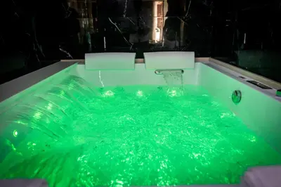 a bath tub with green water in it at Palermo Luxury Rooms Black in Palermo