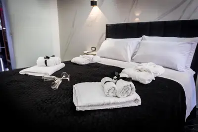 a bedroom with a bed with towels on it at Palermo Luxury Rooms Black in Palermo