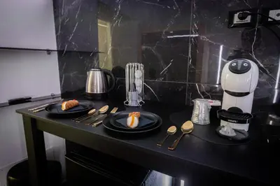 a counter with two plates of food and a blender at Palermo Luxury Rooms Black in Palermo