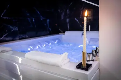 a candle in a bath tub with a candle in it at Palermo Luxury Rooms Black in Palermo