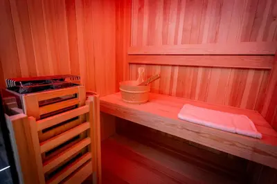a small sauna with a wooden shelf and a utensil at Palermo Luxury Rooms Black in Palermo
