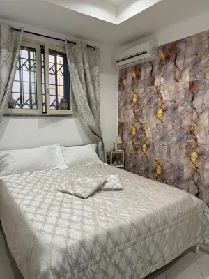 a bedroom with a bed with a wall with flowers at La casa di Tiche in Palermo