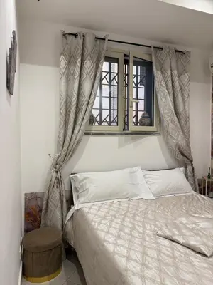 a bedroom with a bed and a window at La casa di Tiche in Palermo