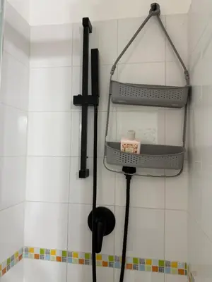 a black hair dryer hanging on a wall at La casa di Tiche in Palermo
