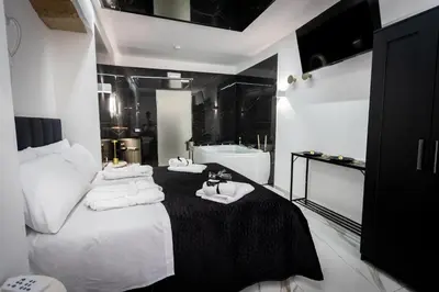 a bathroom with white towels on a bed and a bath tub at Palermo Luxury Rooms White in Palermo