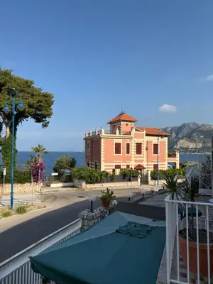 a view of a building with a table on a balcony at Mondello Sunshine Apartment in Mondello