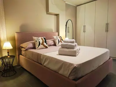 a bedroom with a large bed with towels on it at Il rifugio del Capo in Palermo