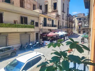 a city street with cars parked on the street at Il rifugio del Capo in Palermo