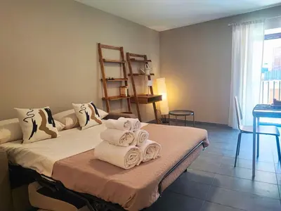 a room with a bed with towels on it at Il rifugio del Capo in Palermo